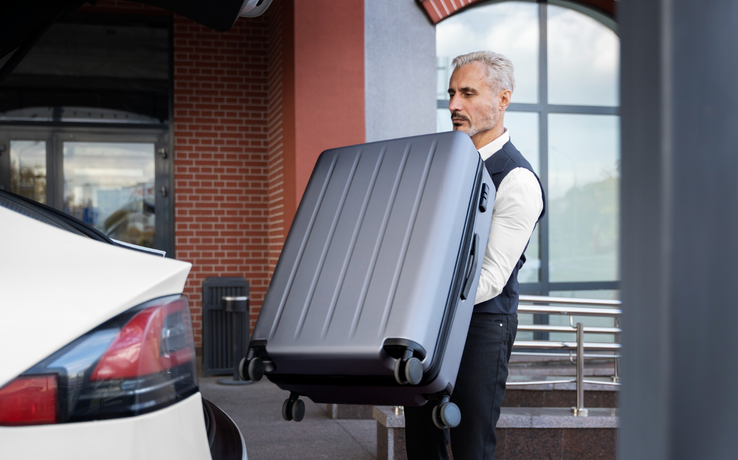 valet holding baggage side view
